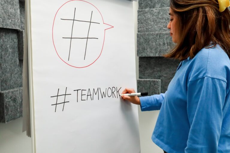 a woman writing on a white board with a marker