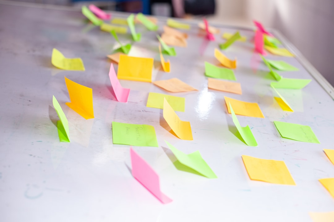 Colorful sticky notes scattered on a white board.