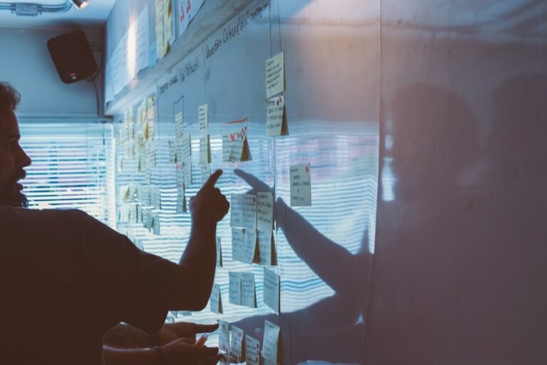 Person pointing white paper on wall — illustrating Answer Engine Optimization: A Practical Strategy Framework